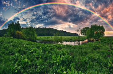 Fototapeta na wymiar Landscape with a Rainbow on the River in Spring. colorful morning. nature of Ukraine