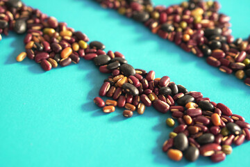 Assortment of many kinds of beans on blue background