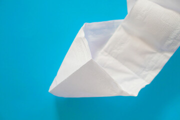 Simple toilet paper on blue background.