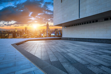 Empty square floor and modern city skyline with buildings at sunset in Ningbo, Zhejiang Province, China.   