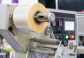 Close up transparent plastic stretch film sheet roll on automatic wrapping or packing machine for...