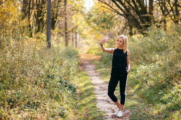 young girl walking in autumn park