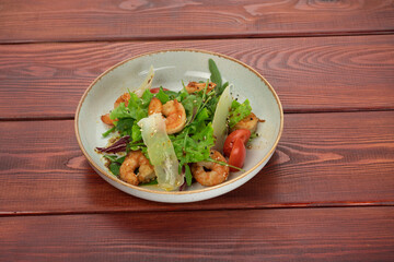 Mix of salad with shrimps , avocado and cherry tomatoes . Healthy food background