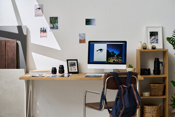 Horizontal image of modern workplace of graphic designer with computer and professional photos on...