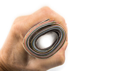 Rolled up magazines in the hand on a white background