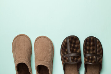 Man's slippers on color background, top view