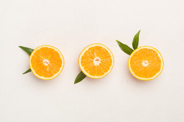 Fresh oranges with leaves on concrete background