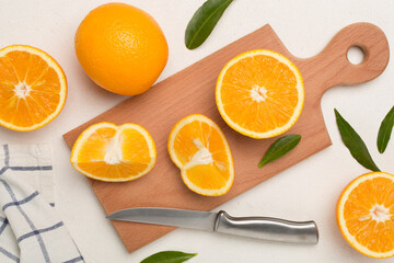 Fresh oranges with leaves on concrete background