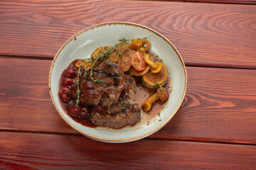juicy beef steak on plates on a wooden table - restaurant menu