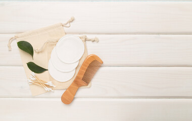 Flat lay with natural biodegradable accessories on wooden background, top view
