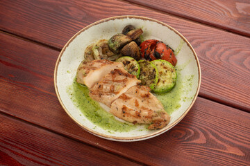 juicy chicken steak on plates on a wooden table - restaurant menu