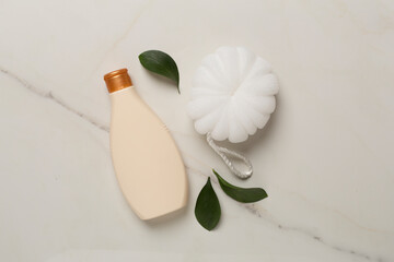 Shower gel with washcloth on marble background, top view