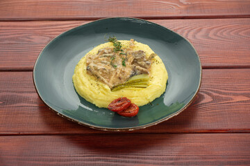 Greek Sofrito Traditional Beef Dish with mashed potatoes from Corfu with mashed potatoes closeup in the plate on the table
