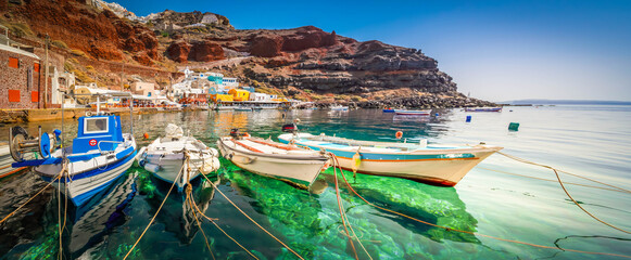 Fototapeta na wymiar Amoudi bay with boats, port of Oia, Santorini Greece at sunny summer, web banner, toned