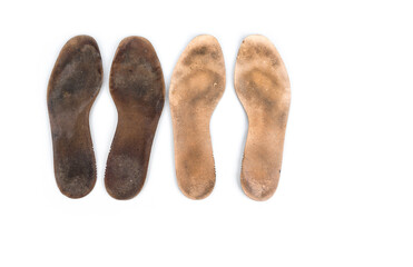 Heavy used insoles on a white background