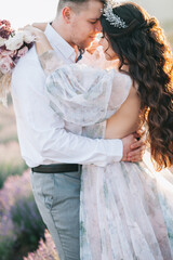 Fototapeta na wymiar Wedding for two on a lavender field. Gorgeous wedding couple.