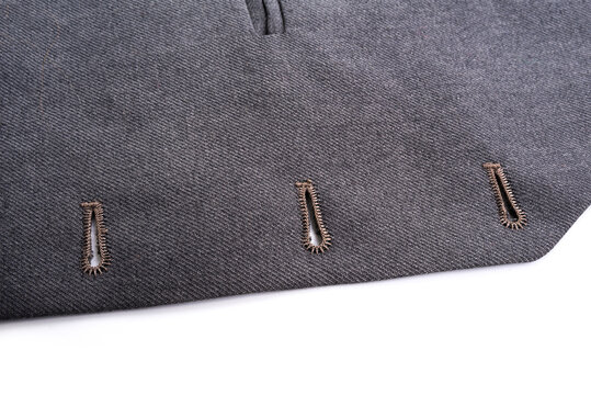 Buttonholes on the vest under the suit.