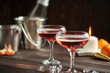 Two glasses of  champagne on dark wooden background. Festive drink. Valentins or Christmas concept.