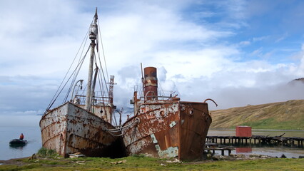 Old, rusted whaling and sealing ships beached in the harbor, at the old whaling station at Grytviken, South Georgia Island - obrazy, fototapety, plakaty