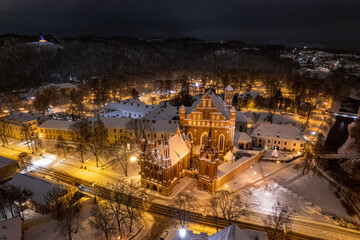 Aerial winter snowy night view of St. Anne's Church (Onos baznycia) Vilnius old town, Lithuania