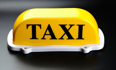 Yellow taxi sign for car roof isolated on black background