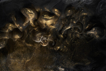 Golden sparkling abstract background, luxury black smoke, acrylic paint underwater explosion, cosmic swirling ink © amixstudio