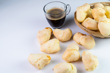 Brazilian Pão de queijo, fresh cheese breads and a hot cup of coffee. Selective focus