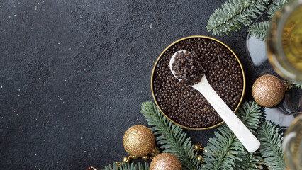 Black caviar appetizers stars on a christmas decorated black table