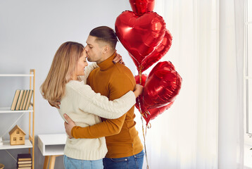 Morning Valentine's romance. Beautiful young couple hugs, kisses and enjoys spending time together...