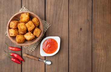 Tapioca dice, typical northeast brazilian food with chilli pepper syrup over wooden table with copy space