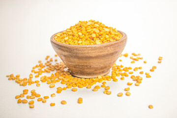 Fototapeta na wymiar Split Chickpea Also Know as Chana Dal, Bright yellow dried chickpea lentils in wooden bowl on white background