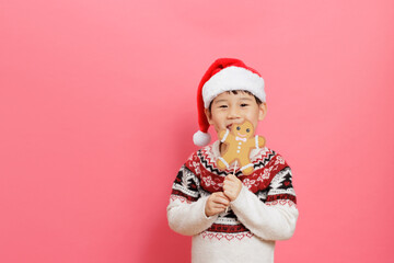 Merry Christmas! Young girl celebrating Christmas against pink background