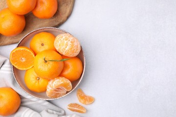 Fresh juicy tangerines on light grey table, flat lay. Space for text