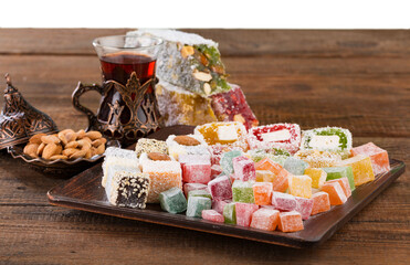 Arabic traditional sweets and berry with tea on plate