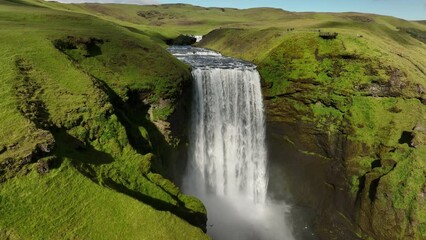 Skogafoss waterfall in Iceland summer day aerial shot summer day green grass sunny day - Powered by Adobe
