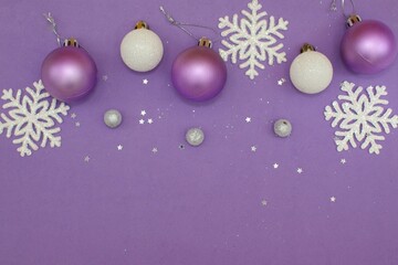 New Year, Christmas concept. White, silver, lilac balls and white snowflakes on a lilac background....
