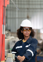 Portrait of a young female engineer in the welding robot industry