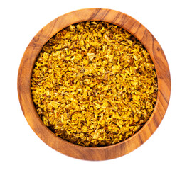 Osmanthus tea in wooden bowl, isolated on white background. Dry flowers of Osmanthus fragrans. Top view.
