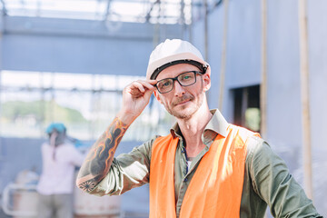 portrait smart middle age builder engineer worker male master skill artisan look with arm tattoo