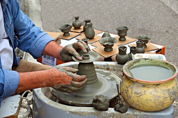 manual working of clay on the lathe with the creation of small objects