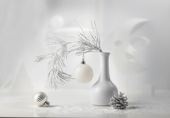Monochrome Christmas still life: pine branch in a white vase, Christmas decorations, abstract