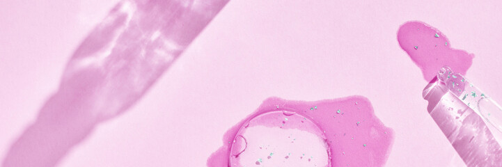 Serum gel texture swatch. Transparent drop with golden sparkles. Pink background. Face skincare...