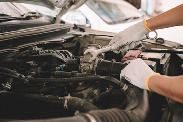 Automobile mechanic man checking car damage broken part condition, and repairing vehicle at home...