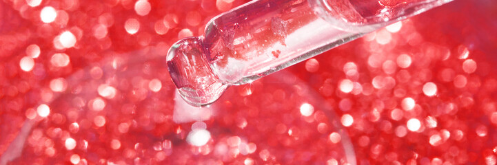 Serum gel texture swatch. Transparent drop with sparkles. Red bokeh background. Face skincare...