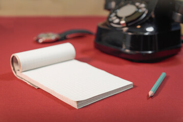 Retro notepad with plase for text.  vintage office table with notepad, penscil and old phone.