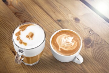 Tasty hot coffee with cream in glass