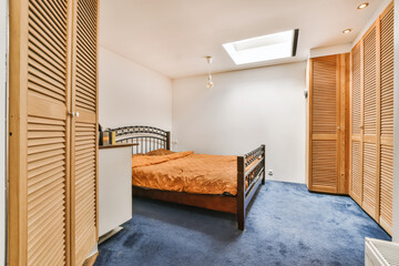 a bedroom with wooden shutters on the wall and bed in front of the door to another room that has...