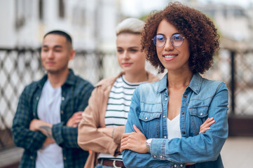 Three multiethnic young people on the veranda