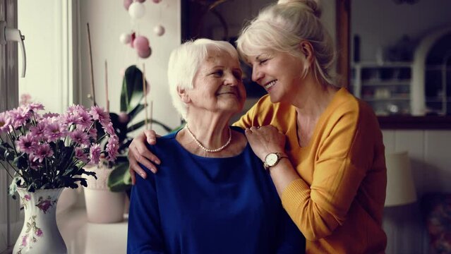Woman spending time with her elderly mother at home

