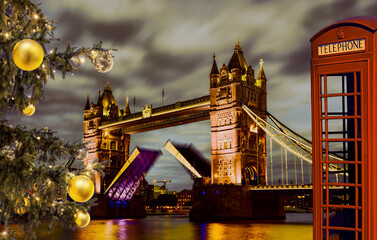 Tower Bridge lift time against Christmas tree and red phone booth in London, UK